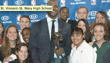 Lebron James holding his MVP trophy with St. Vincent-St. Mary student